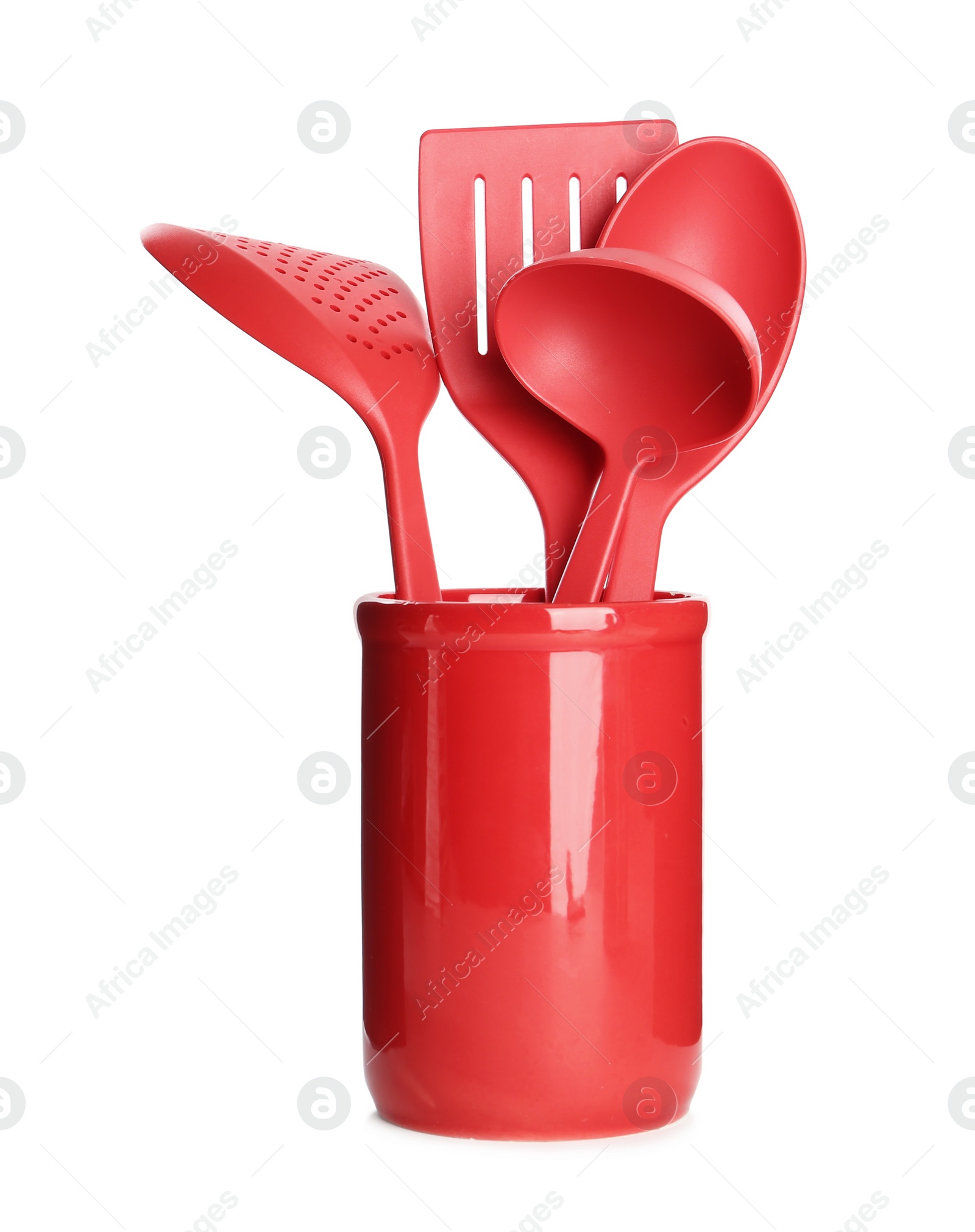Photo of Set of red cooking utensils in holder isolated on white