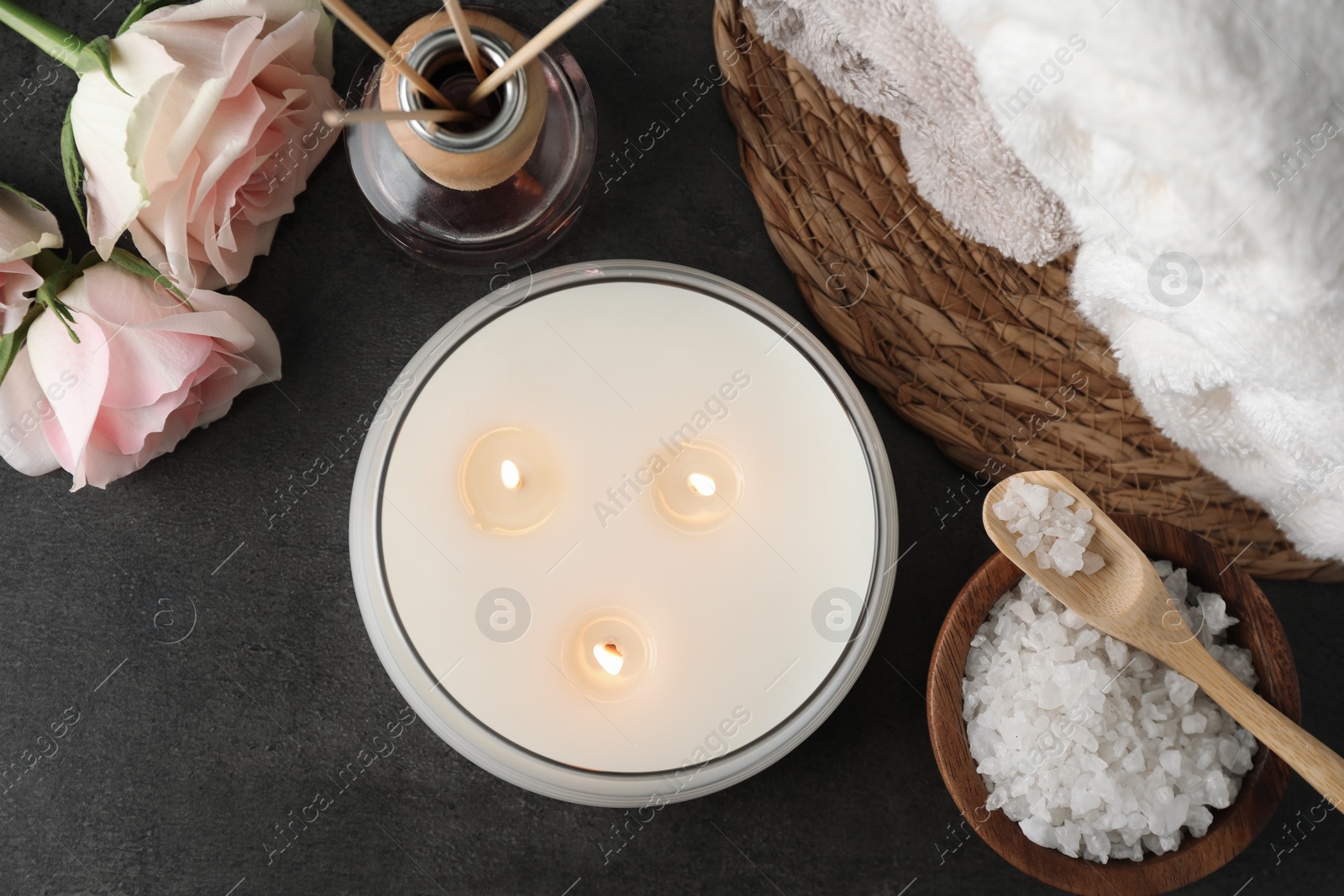 Photo of Flat lay composition with different spa products and rose flowers on grey table