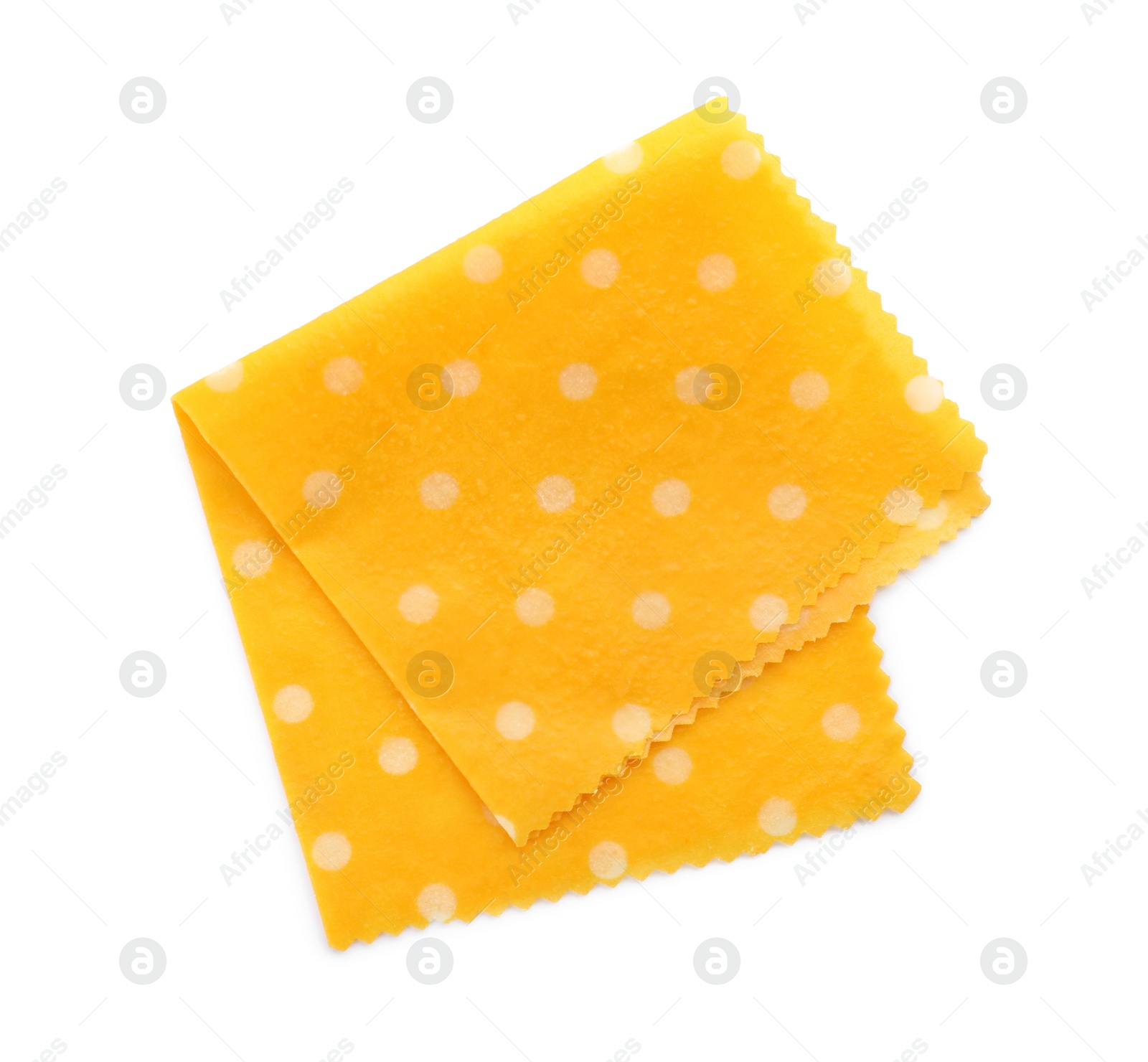 Photo of Yellow reusable beeswax food wrap on white background, top view