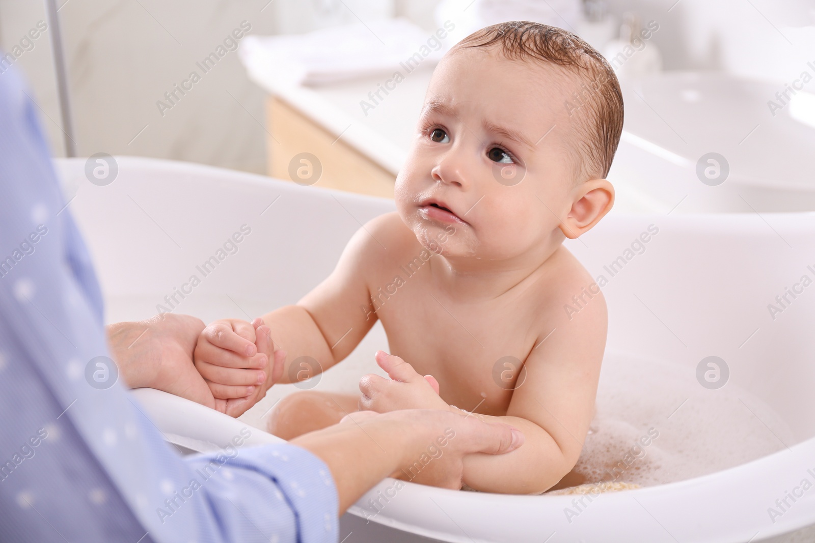 Photo of Mother with her little baby in bathroom