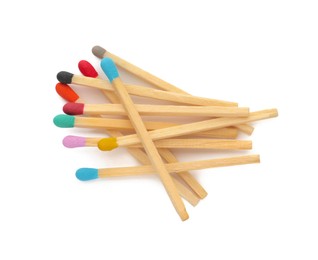 Matches with colorful heads on white background, top view