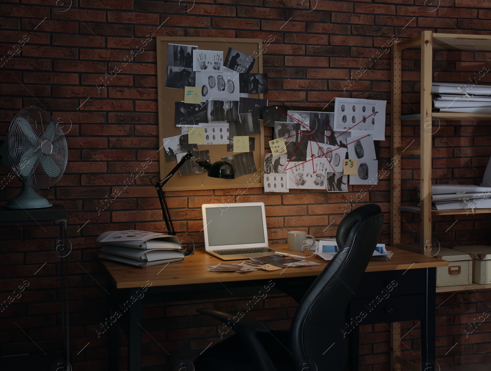 Photo of Workplace with laptop and detective board in office