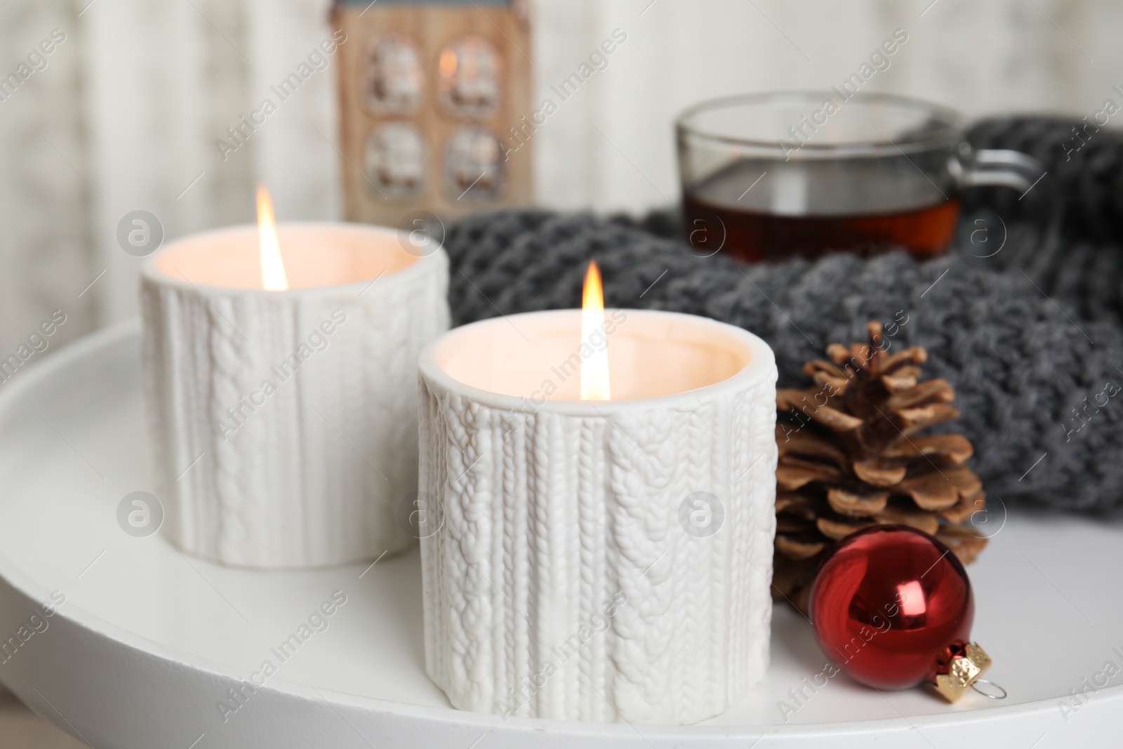 Photo of Composition with candles in ornate holders on table. Christmas decoration