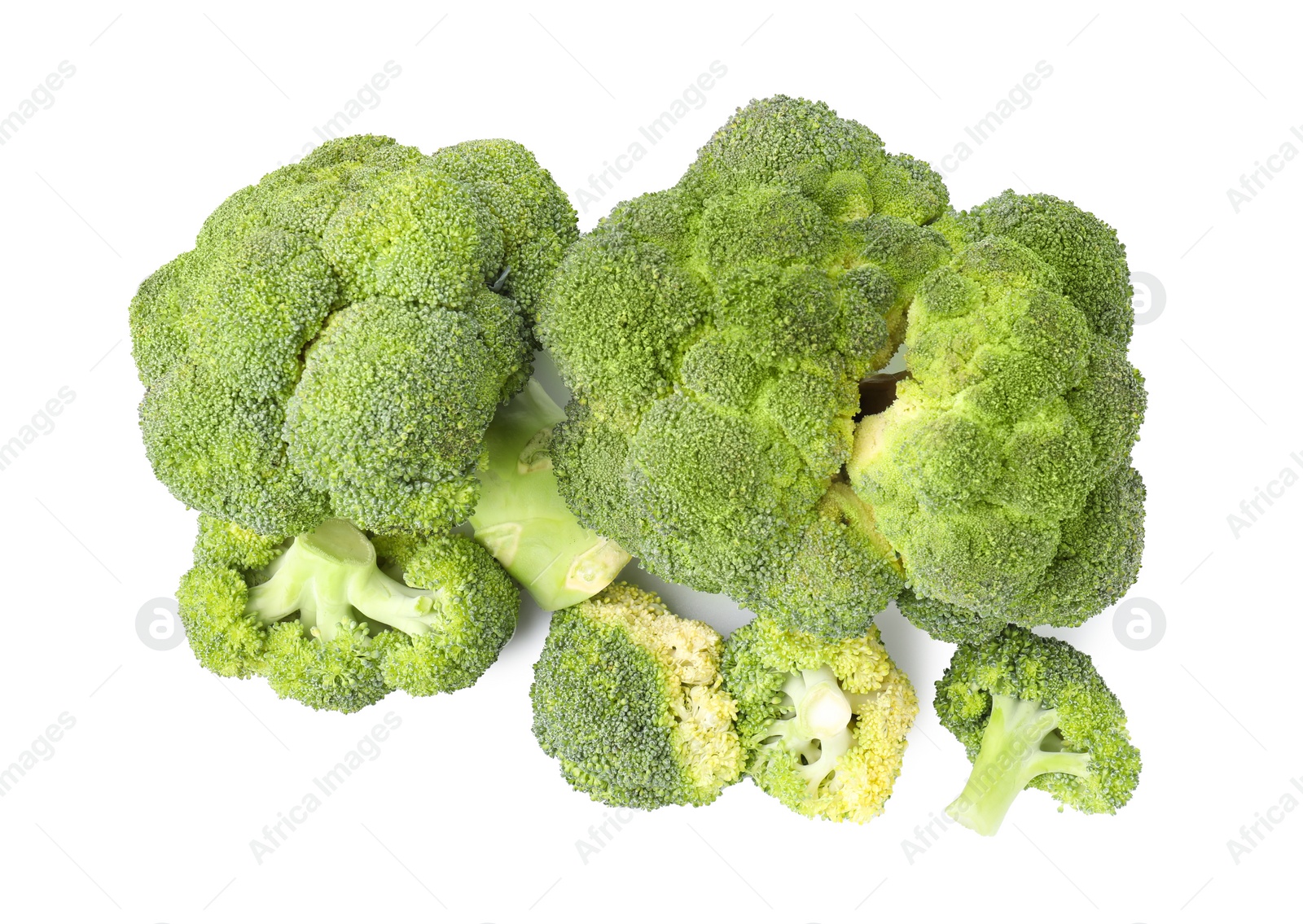 Photo of Pile of fresh raw green broccoli isolated on white, top view