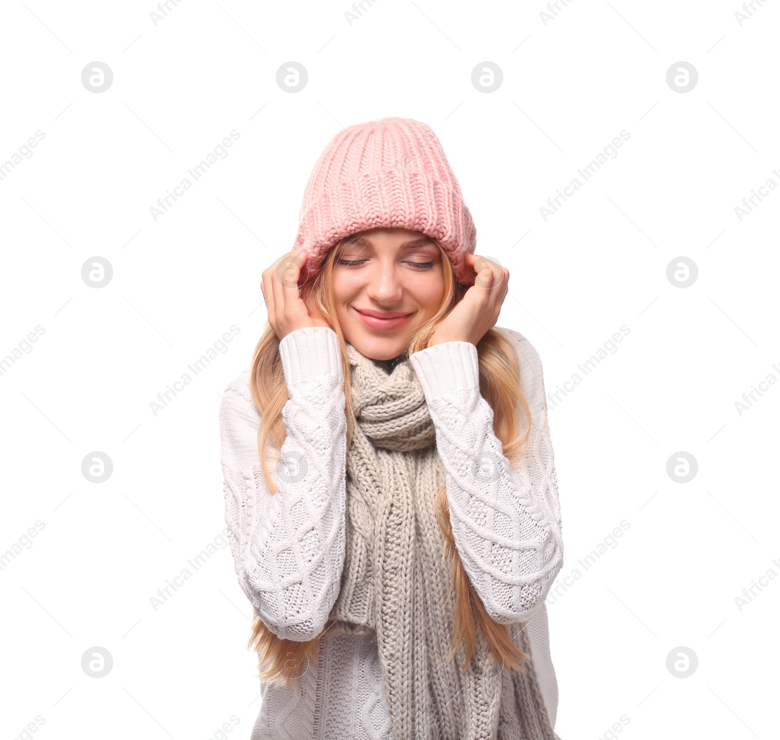 Photo of Portrait of emotional young woman in stylish hat and sweater with scarf on white background. Winter atmosphere