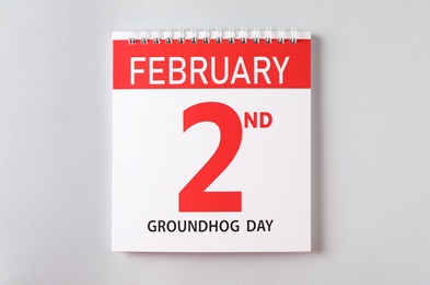 Photo of Top view of calendar with date February 2nd on light background. Groundhog day