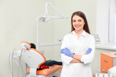 Photo of Professional dentist and patient in modern clinic