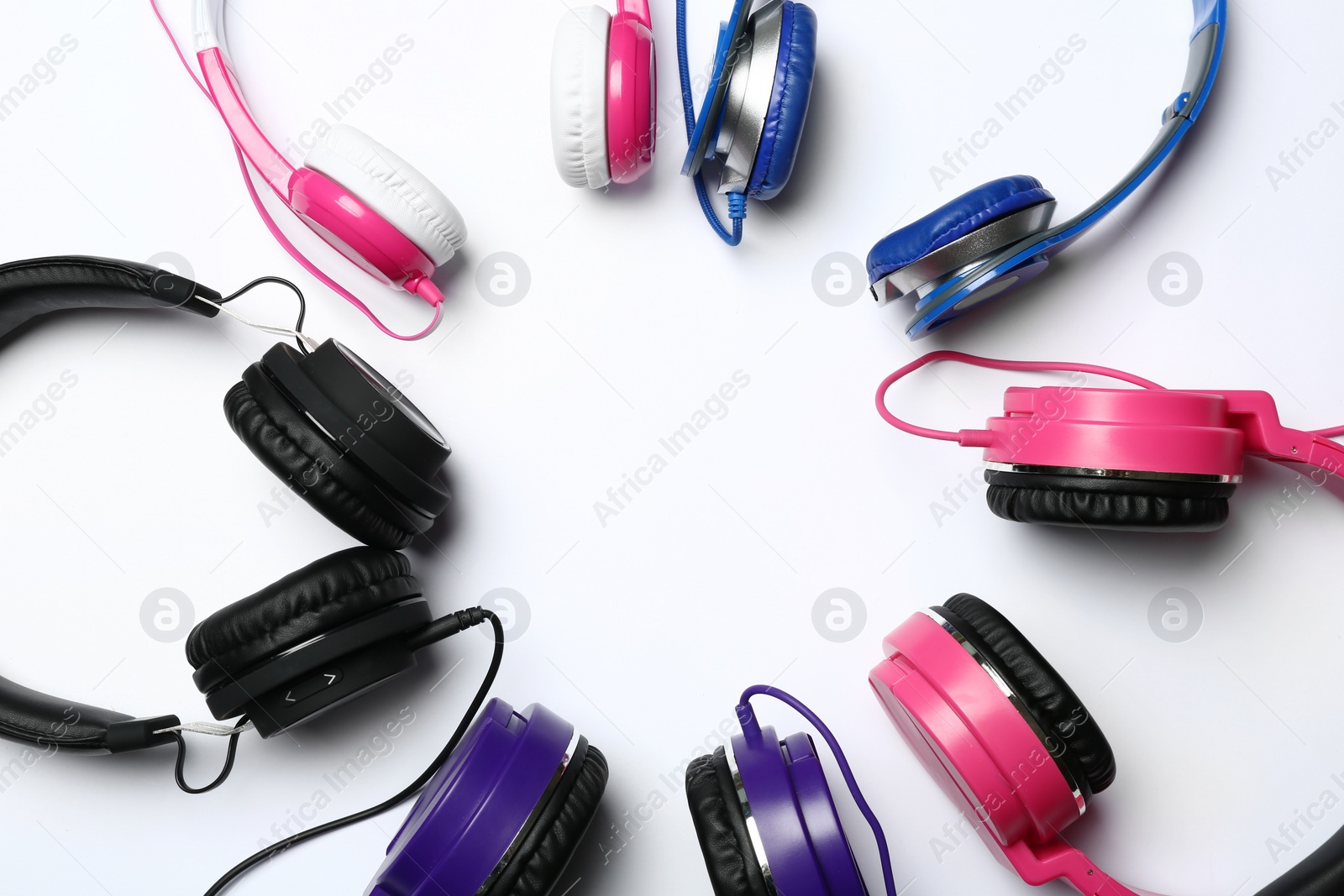 Photo of Frame made of modern headphones on white background, top view. Space for text