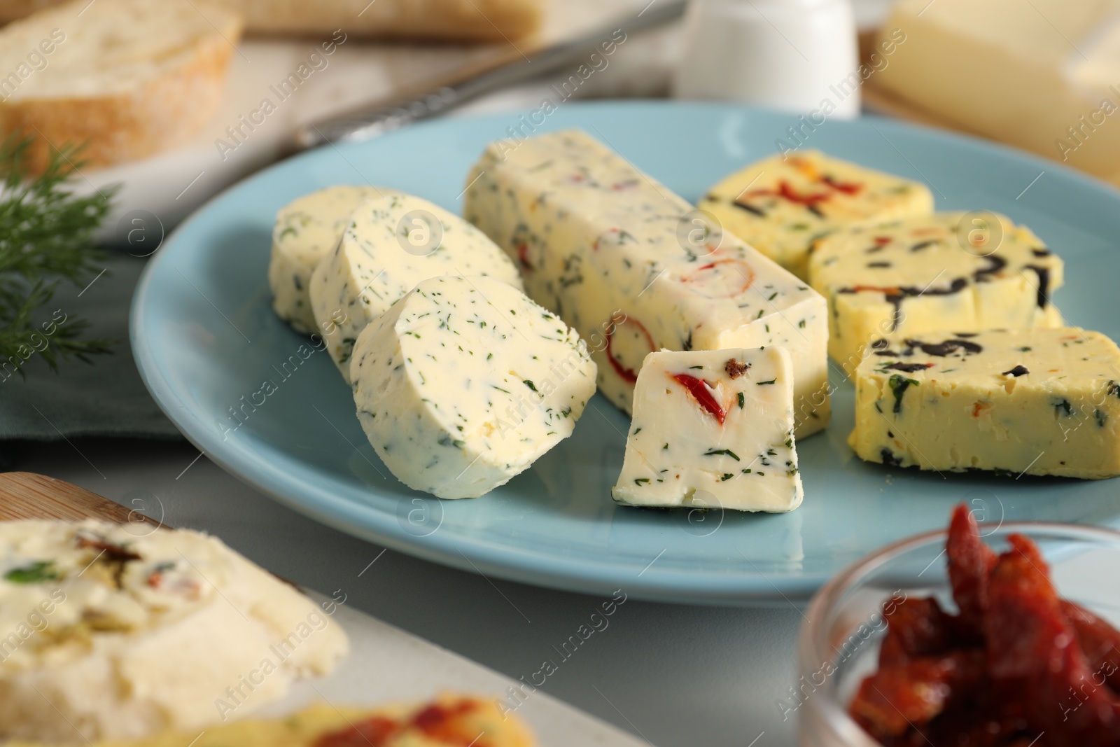 Photo of Different types of tasty butter on white table, closeup