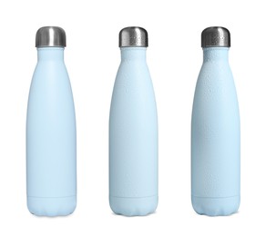 Set with stylish closed thermo bottles on white background