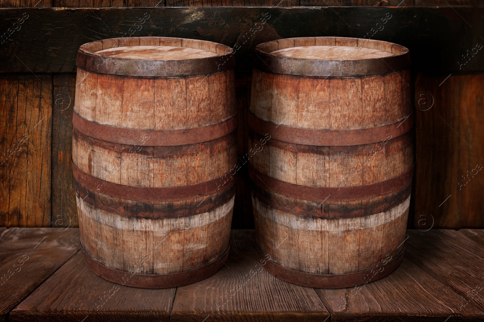 Image of Wooden barrels on brown shelf near textured wall