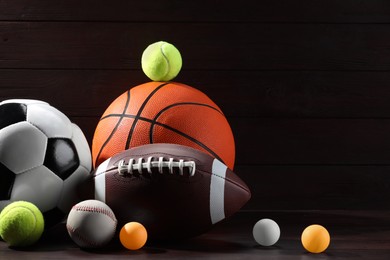 Photo of Many different sport balls on wooden background, space for text