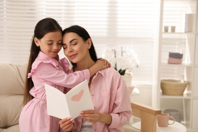 Little daughter congratulating her mom at home. Happy Mother's Day