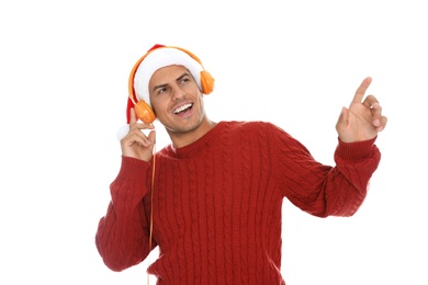 Photo of Emotional man with headphones on white background. Christmas music