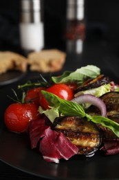 Photo of Delicious salad with roasted eggplant and basil on plate, closeup