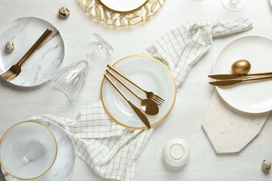 Photo of Festive Easter table setting on wooden background, top view