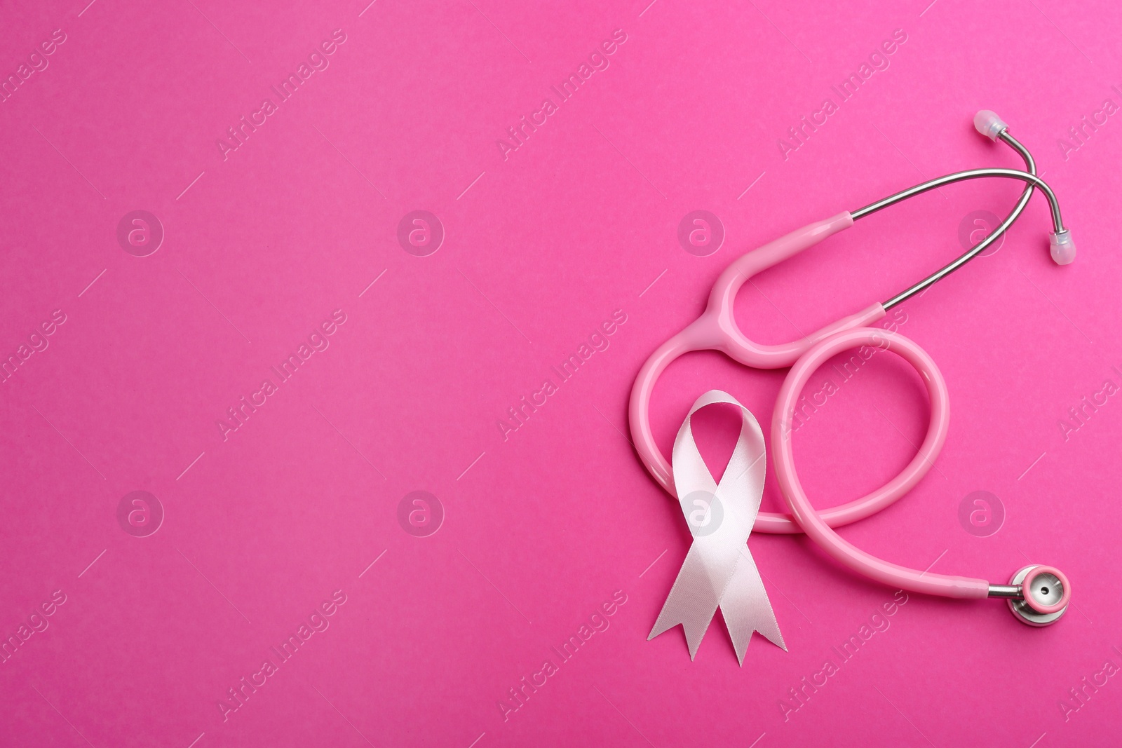 Photo of Pink ribbon and stethoscope on color background, flat lay with space for text. Breast cancer concept