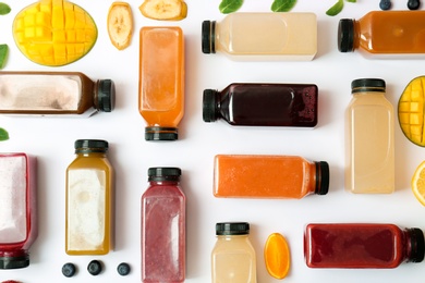 Photo of Flat lay composition with healthy detox smoothies and ingredients on light background