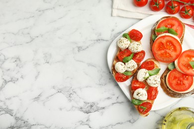 Photo of Delicious sandwiches with mozzarella, fresh tomatoes and basil on white marble table, flat lay. Space for text