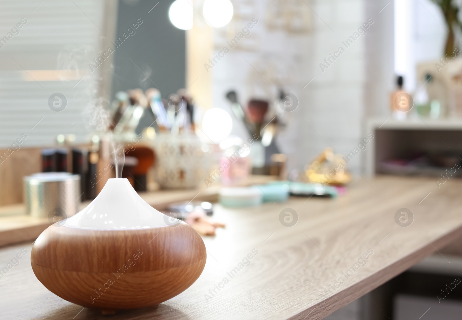 Photo of Aroma oil diffuser on wooden table, closeup