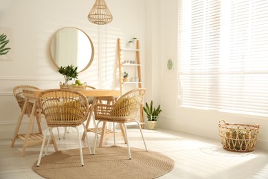 Photo of Stylish wooden dining table and chairs in room. Interior design