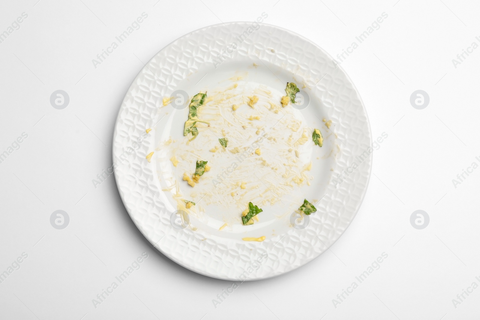 Photo of Dirty plate with food leftovers on white background, top view