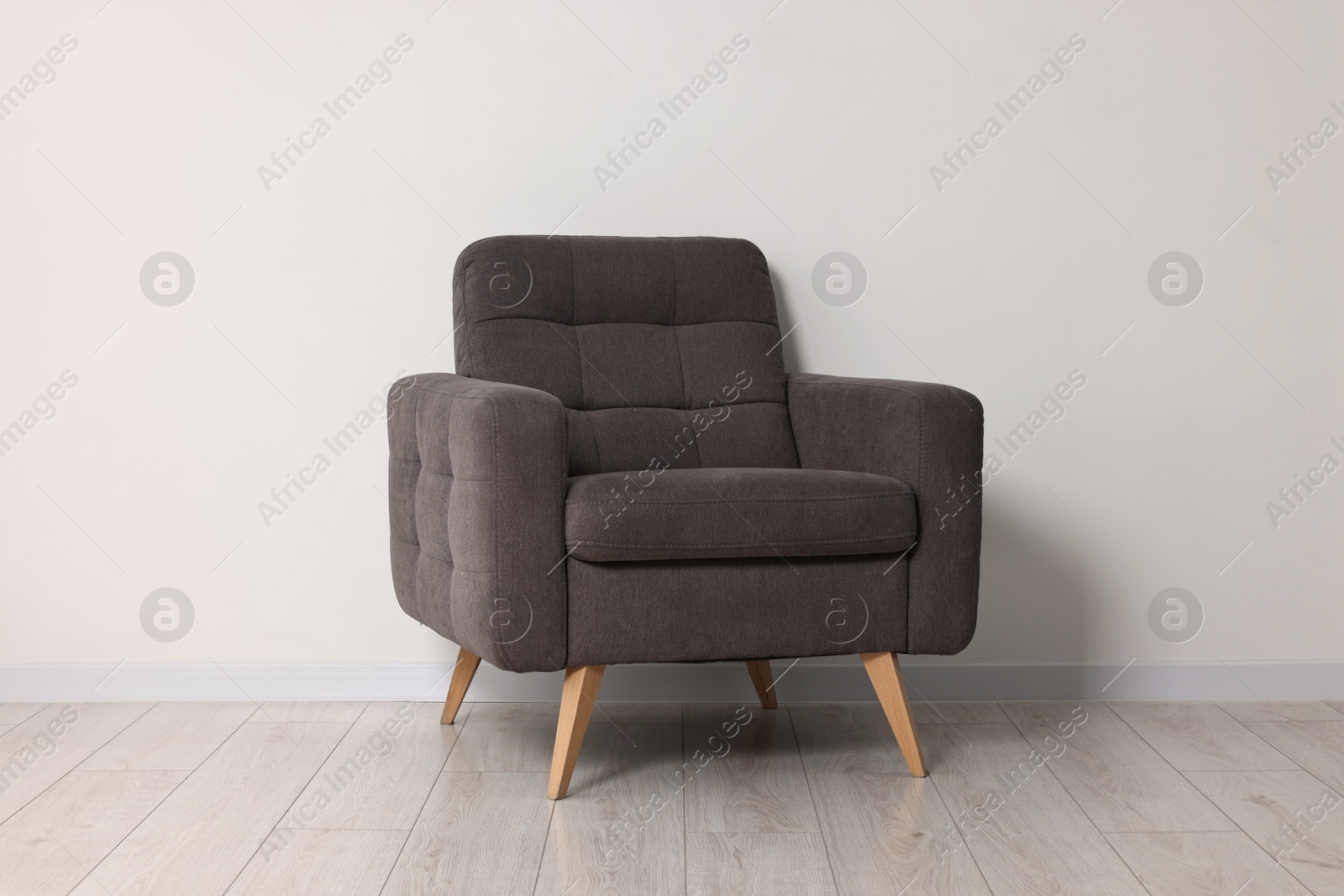 Photo of Comfortable armchair near white wall in room