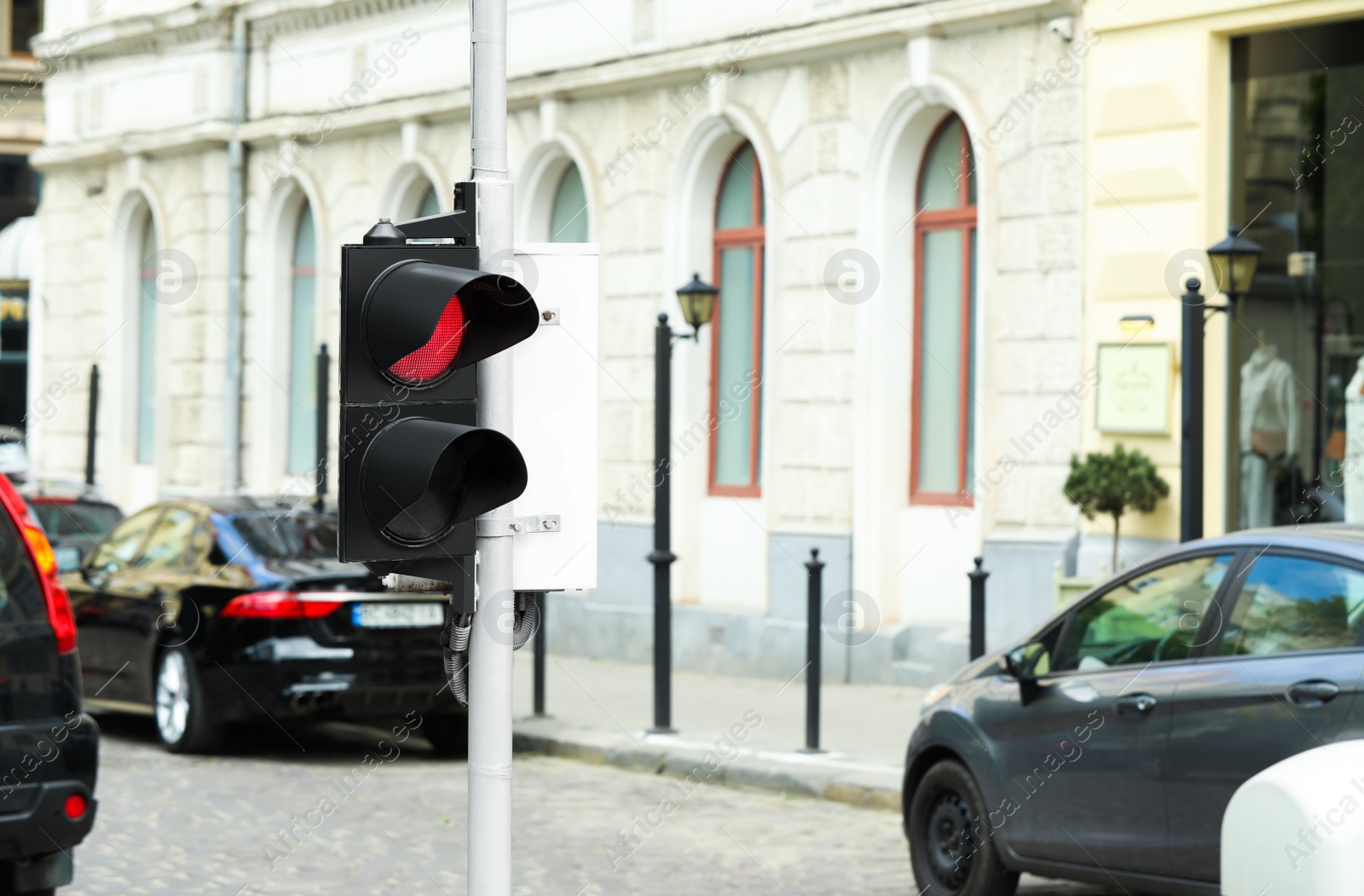 Photo of Post with traffic light on city street