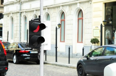 Post with traffic light on city street