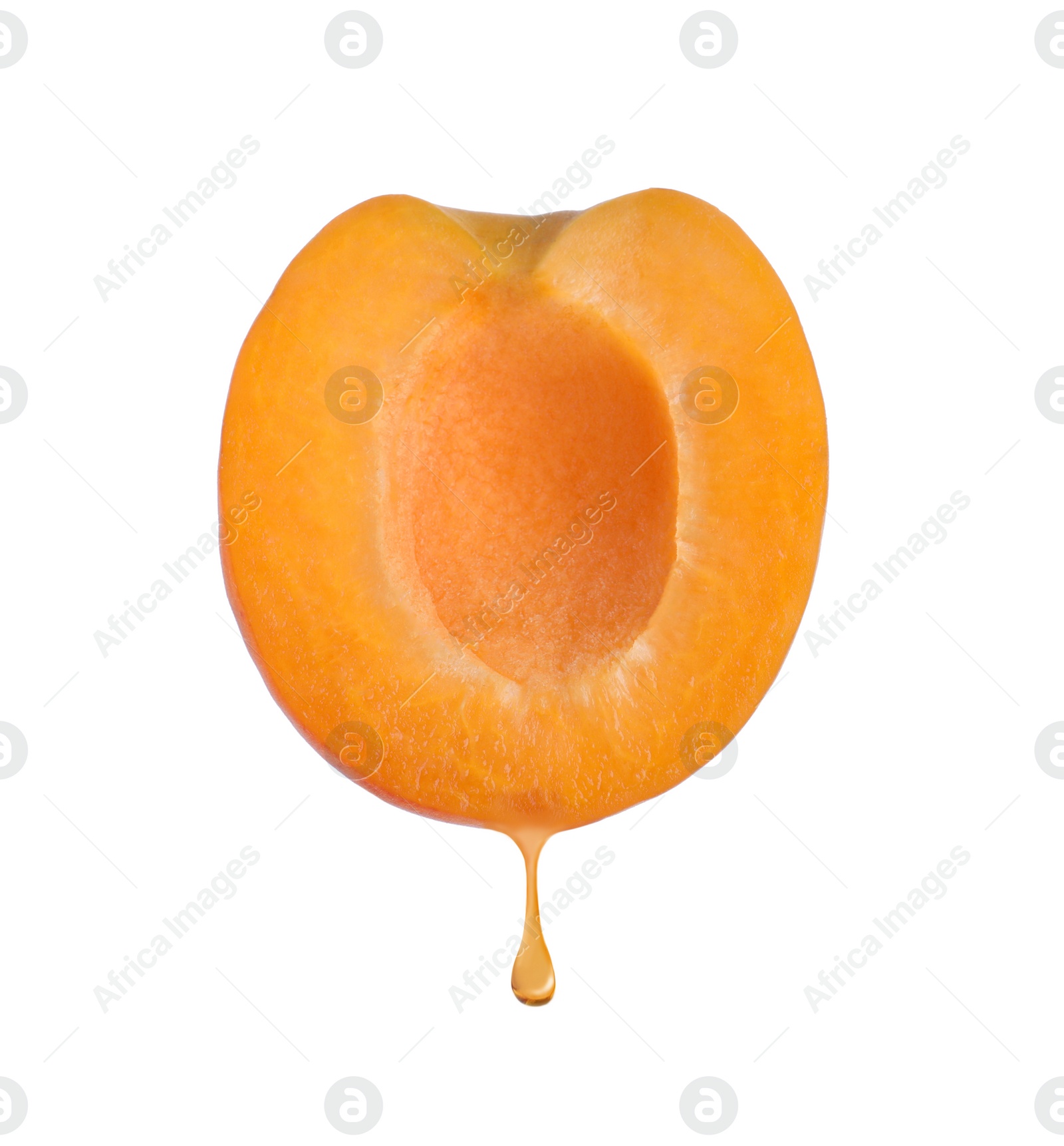 Image of Apricot oil dripping from fresh fruit half on white background