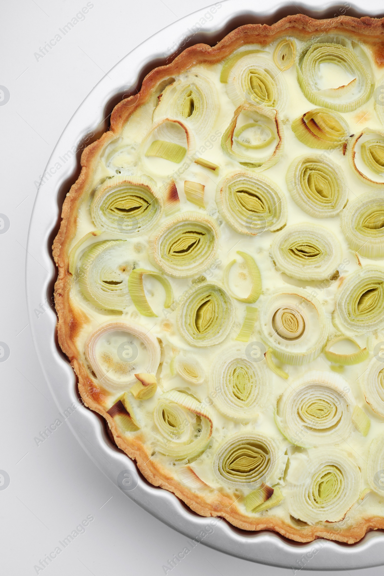 Photo of Freshly baked leek pie on white background, top view