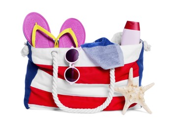 Photo of Stylish bag with starfish and other beach accessories isolated on white