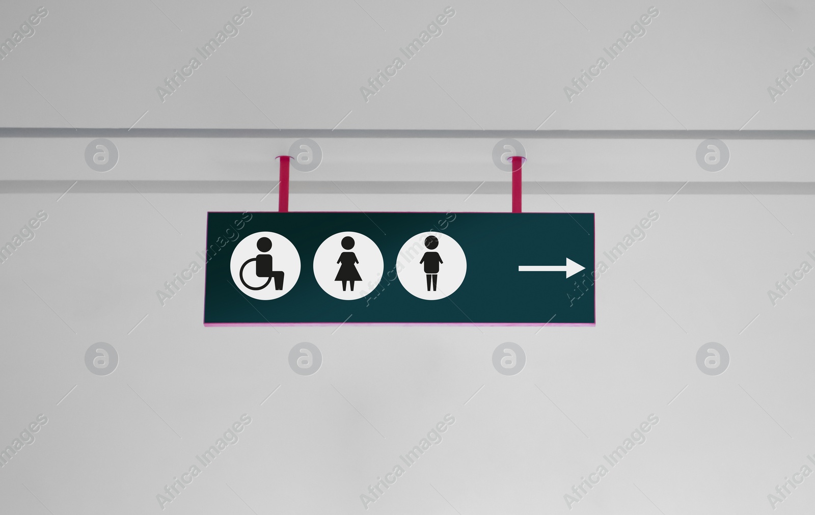 Image of Public toilet sign with symbols and arrow showing direction