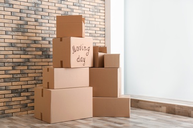 Photo of Pile of moving boxes in empty room