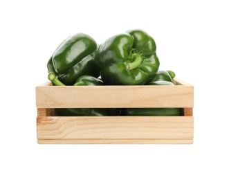 Wooden crate with ripe green bell peppers on white background