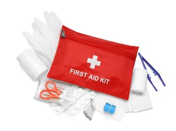 Photo of Red first aid kit, scissors, pins, gloves, cotton buds, pills, plastic forceps and elastic bandage isolated on white, top view