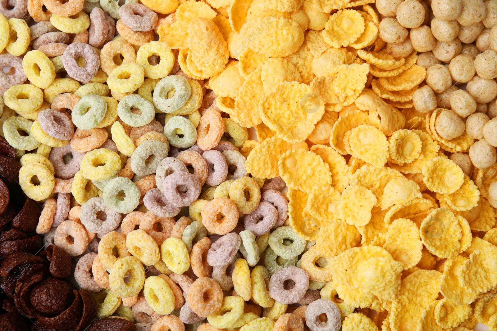 Photo of Different types of breakfast cereals as background, top view