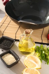 Photo of Wok and different products on white wooden table, closeup