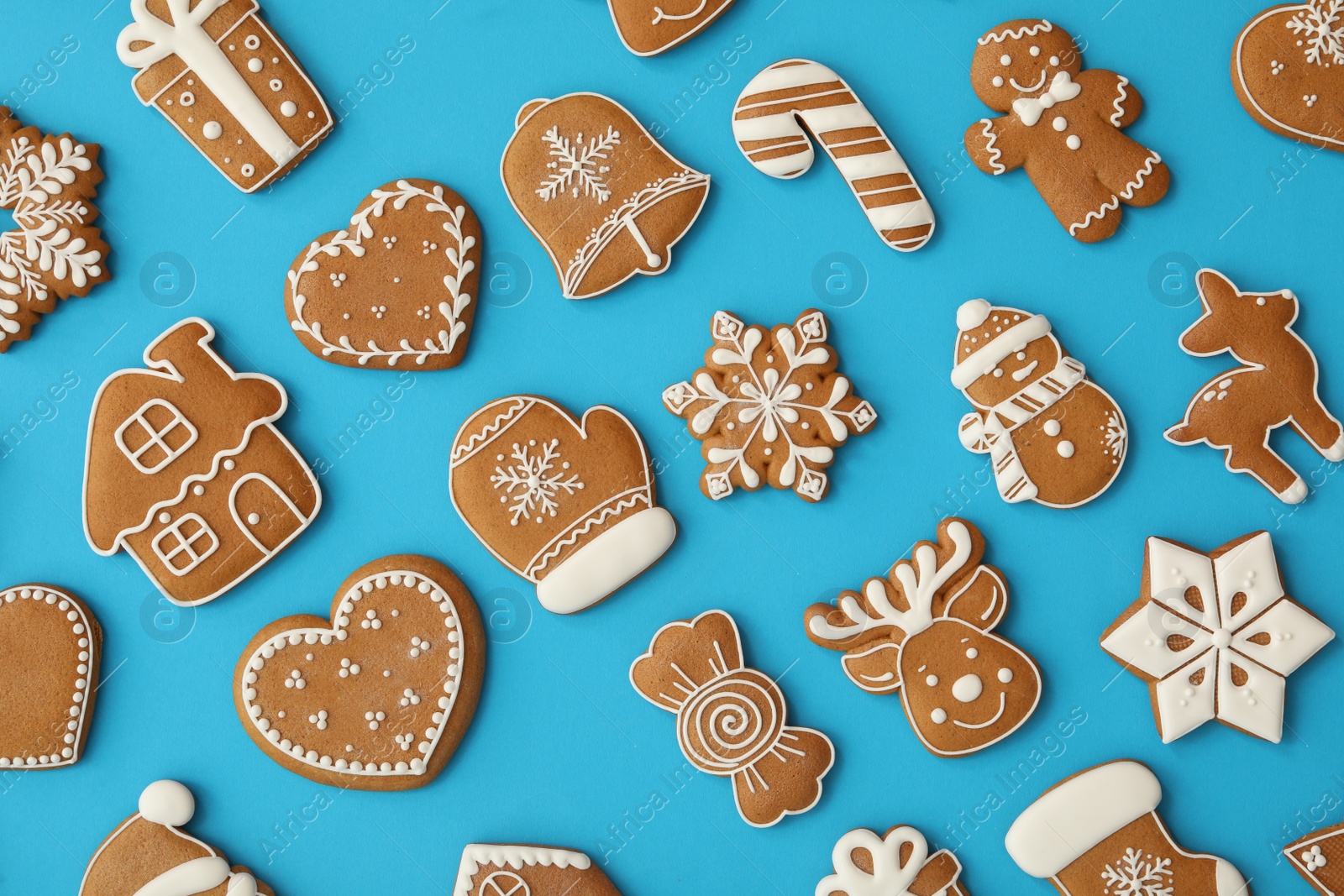 Photo of Different Christmas gingerbread cookies on light blue background, flat lay