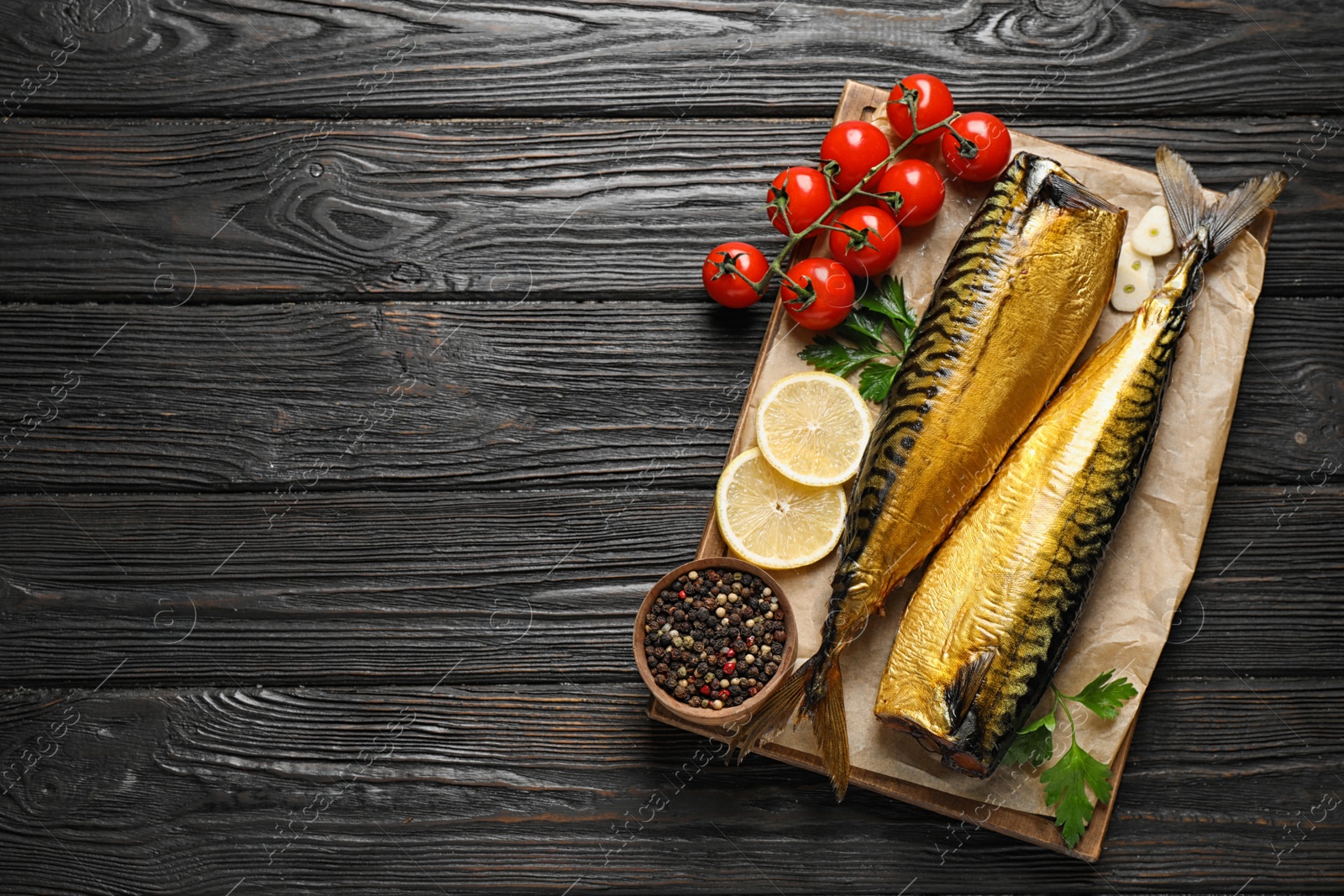 Photo of Tasty smoked fish on wooden table, top view. Space for text