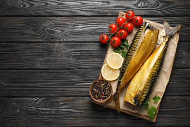 Tasty smoked fish on wooden table, top view. Space for text