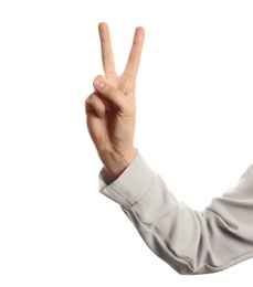 Photo of Young woman showing victory gesture on white background