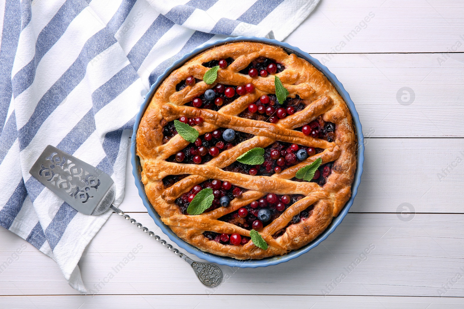 Photo of Delicious currant pie and fresh berries on white wooden table, flat lay