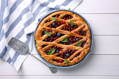 Photo of Delicious currant pie and fresh berries on white wooden table, flat lay