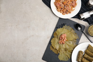 Ingredients for preparing stuffed grape leaves on light table, flat lay. Space for text