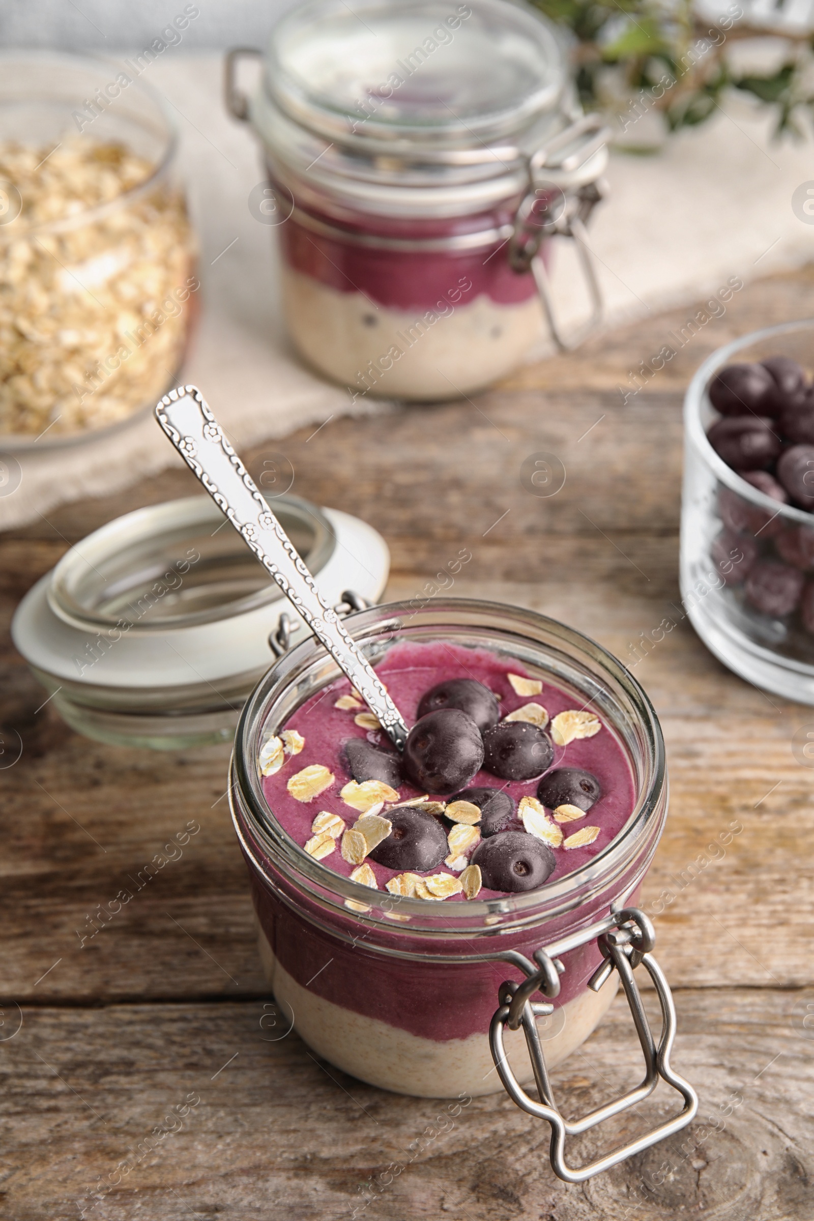 Photo of Jar with tasty acai smoothie on wooden table