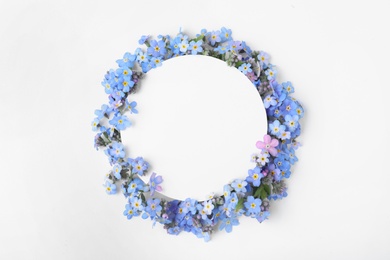 Photo of Composition with amazing forget-me-not flowers and blank card on white background, top view