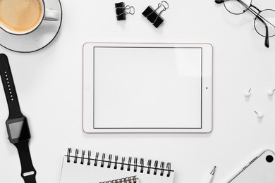 Flat lay composition with modern tablet on white background. Space for text