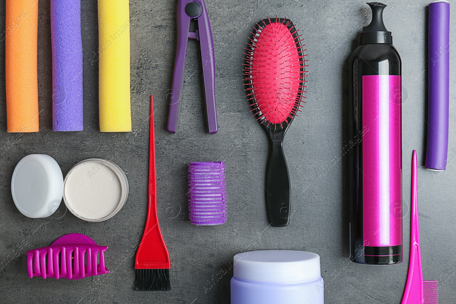 Photo of Flat lay composition with professional hairdresser tools on grey background