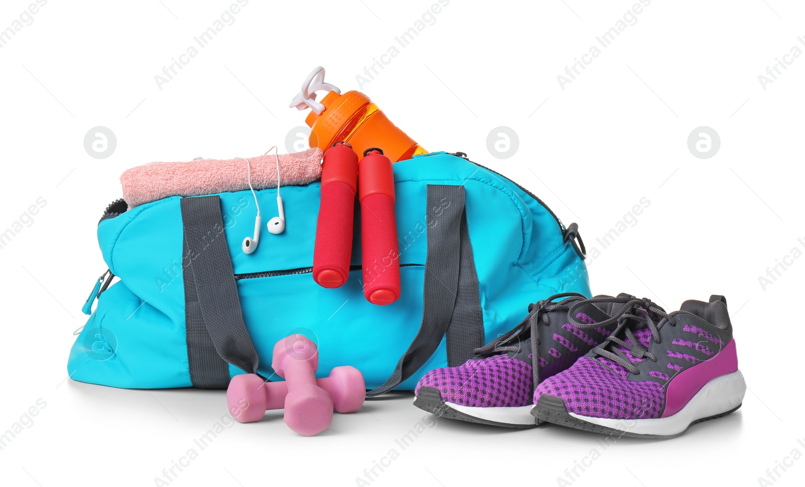 Photo of Sports bag and gym equipment on white background